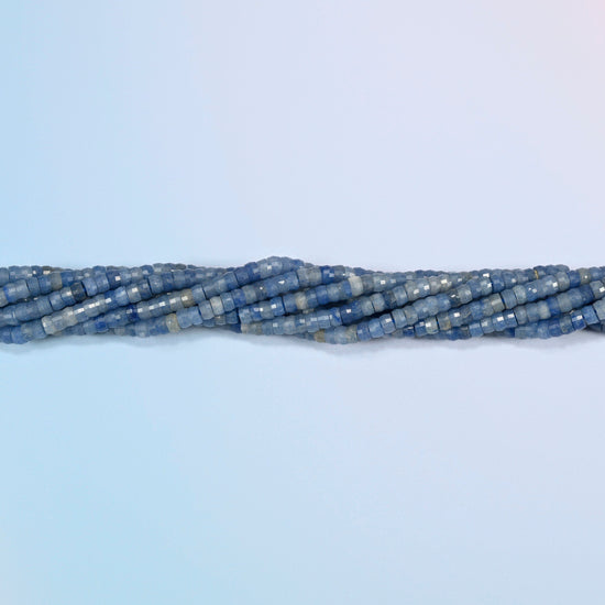 Strands of blue aventurine faceted heishi disc beads twisted together in a horizontal row