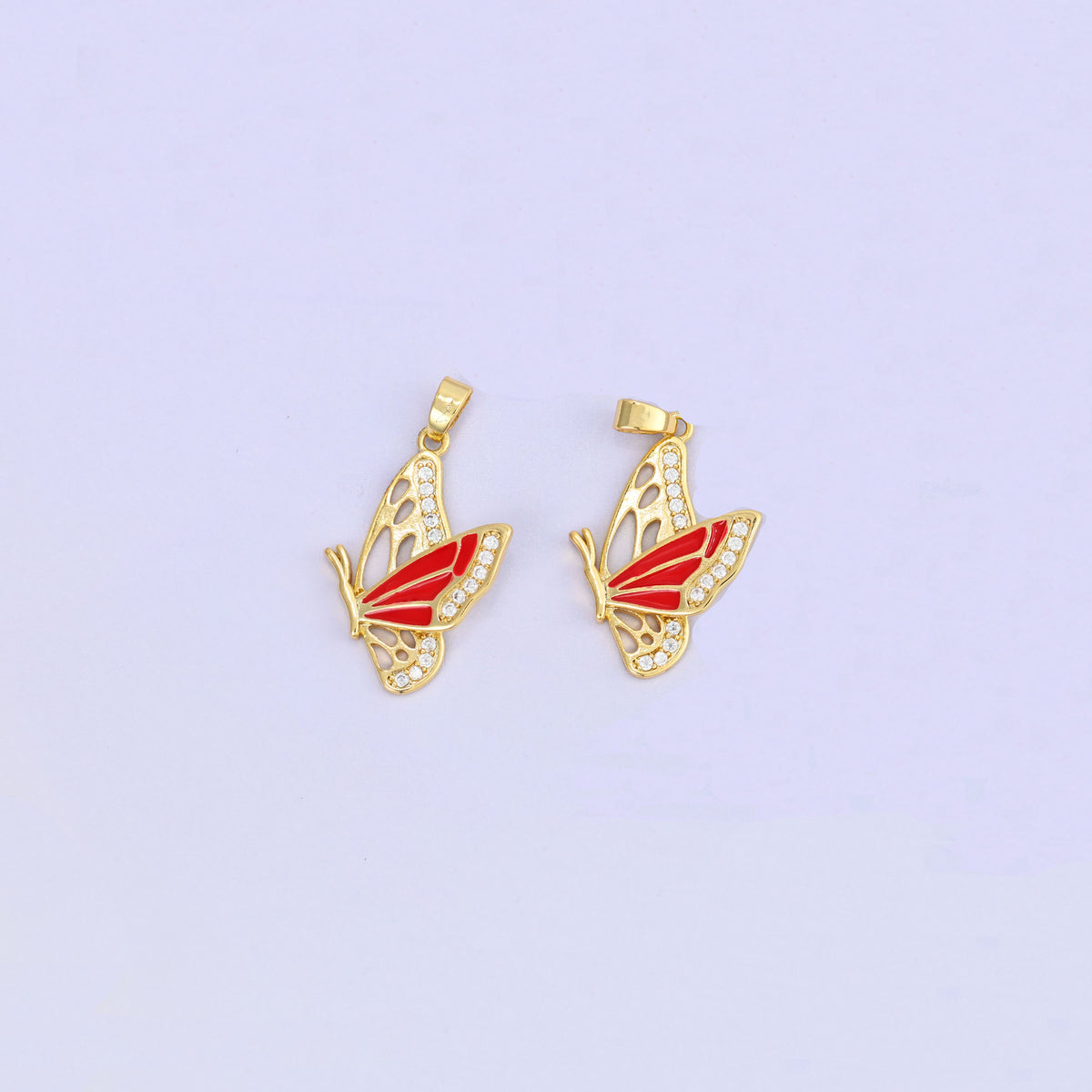 Flying butterfly charm pendants in red, two 18K gold plated side on butterflies with red enamel wing panels, zircon edging and cut out gold veining.