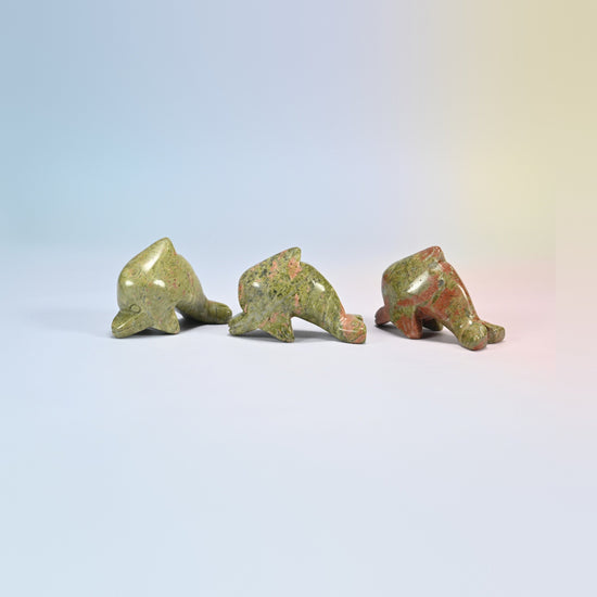 Three unakite dolphin crystal carvings, green and pink natural stone