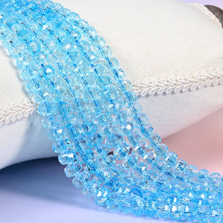 Transparent blue faceted rondelle glass beads, crisp aqua-blue with sharply cut facets around the rim