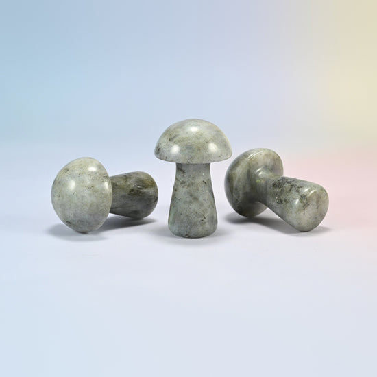 Three 2 inch gray labradorite mushroom crystal carvings shown standing and lying, gray-green natural stone