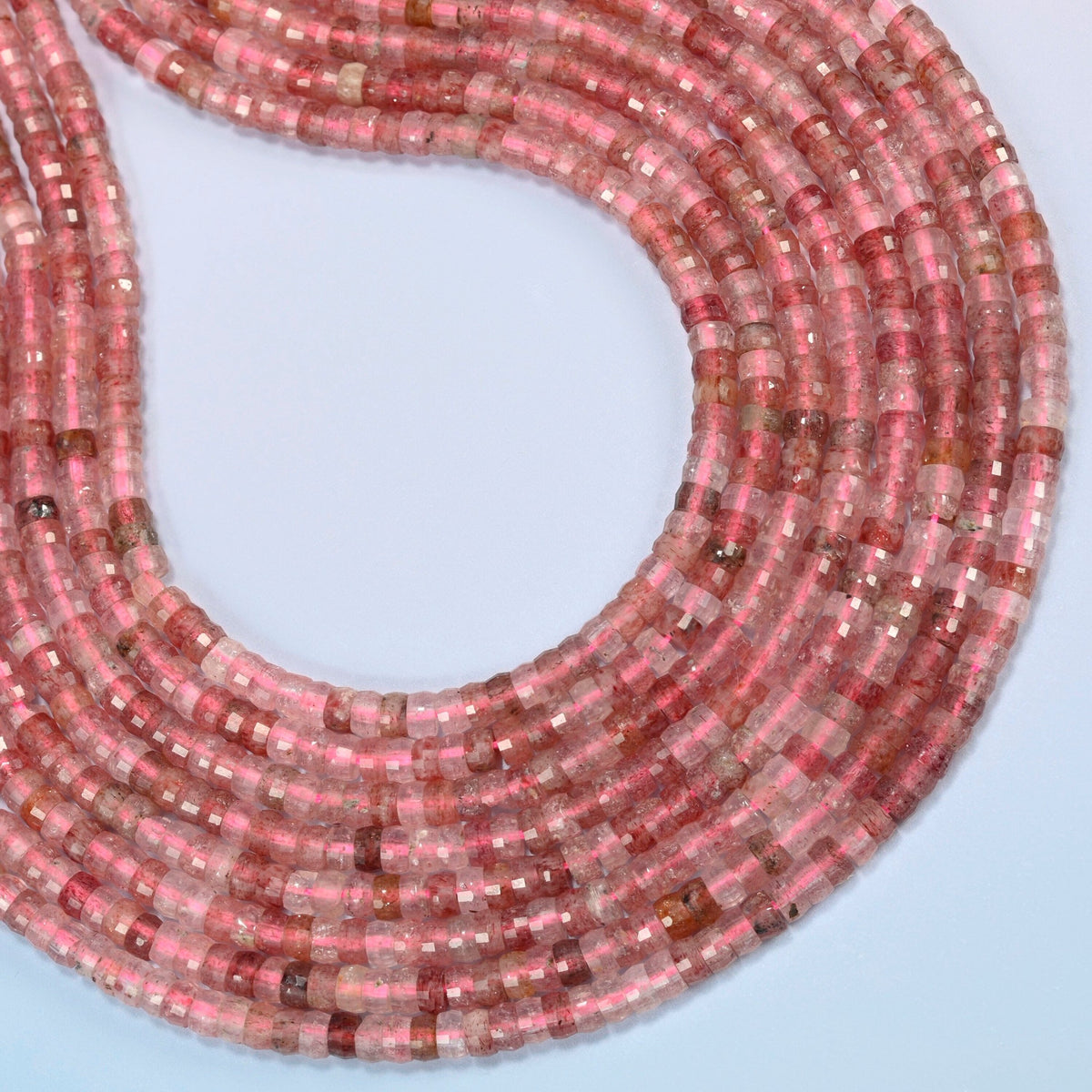 Strawberry quartz faceted heishi disc beads curved into an open loop, pink and clear beads