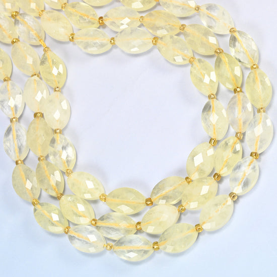 Citrine faceted flat oval beads curved into an open loop, light lemon yellow translucent beads