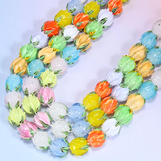 Close-up rows of pastel tulip bud lampwork glass beads from a different angle, showing the mix of soft colors.
