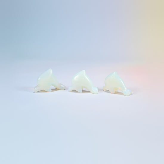 Three opalite dolphin crystal carvings, 1.5 inch, glowing milky white man-made glass