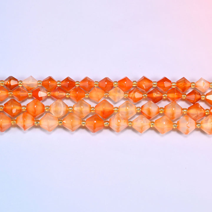 Straight parallel rows of orange carnelian faceted bicone beads, a gold glass seed bead between every stone.