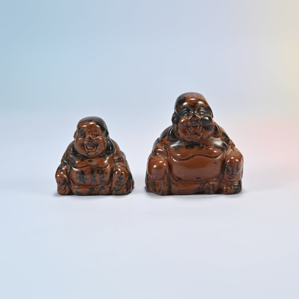 A 1.5 inch and a 2 inch golden swan laughing Buddha crystal carving, red-brown natural stone with black patches