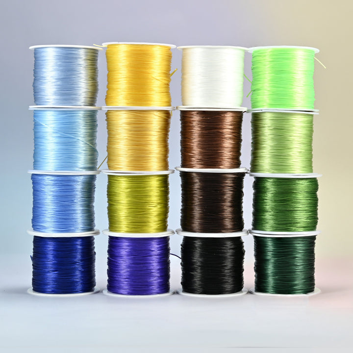Sixteen rolls of 0.7-0.8mm elastic stretch string in cool and neutral colors: sky blue, royal blue, gold, yellow, clear, brown, black, lime green and dark green