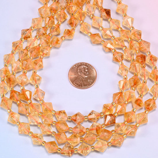 Citrine bicone beads coiled into a ring, seen from above, honey and amber tones sitting together.