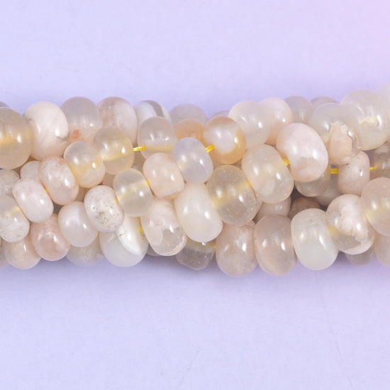 Rondelle cut Sakura Agate beads with a smooth polished finish