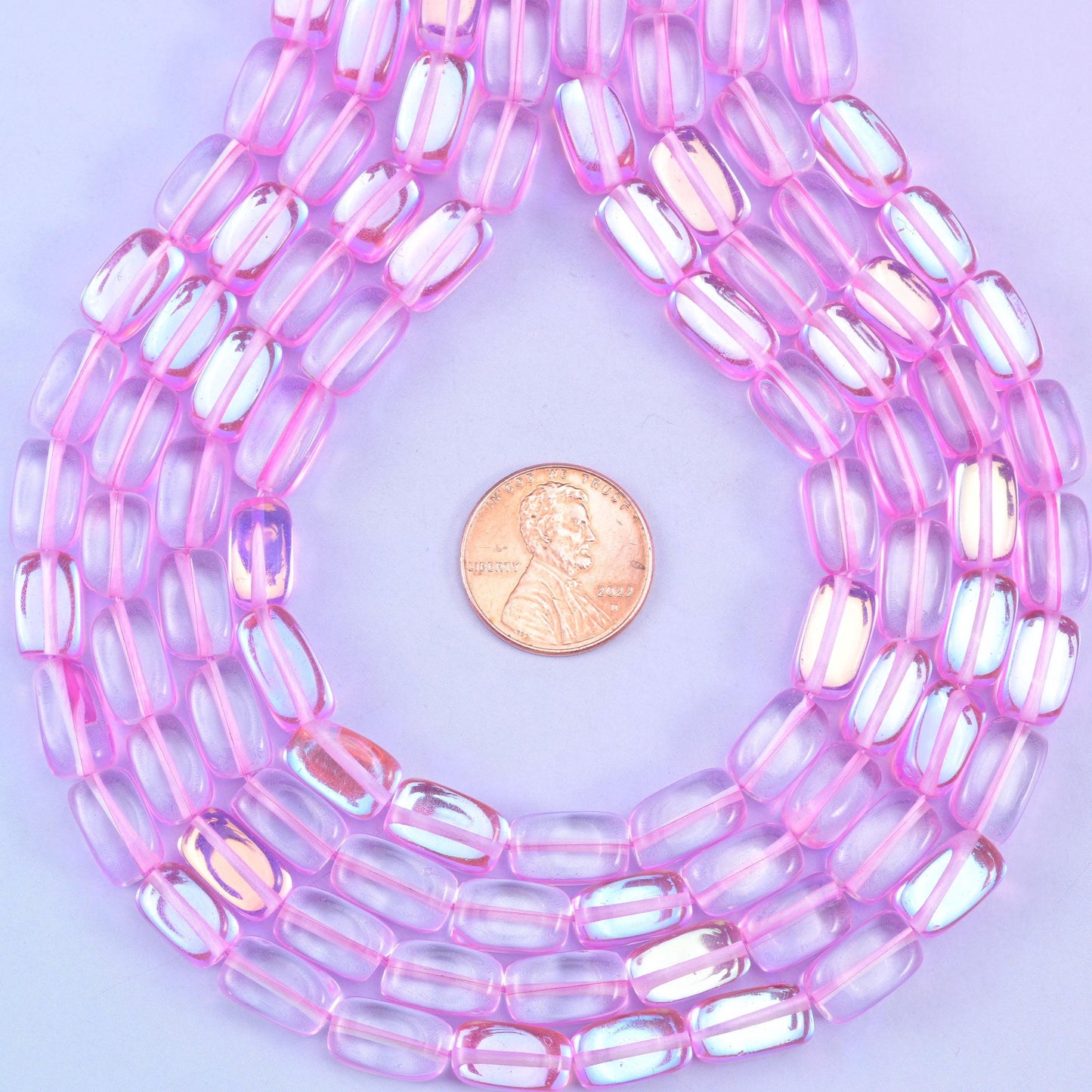 Pink mystic aura rectangle glass beads, glossy transparent finish with bubblegum-pink shine