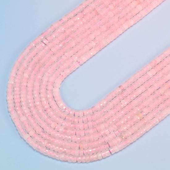 Rose quartz faceted heishi disc beads in several strands curved into a wide U, soft translucent pink stone