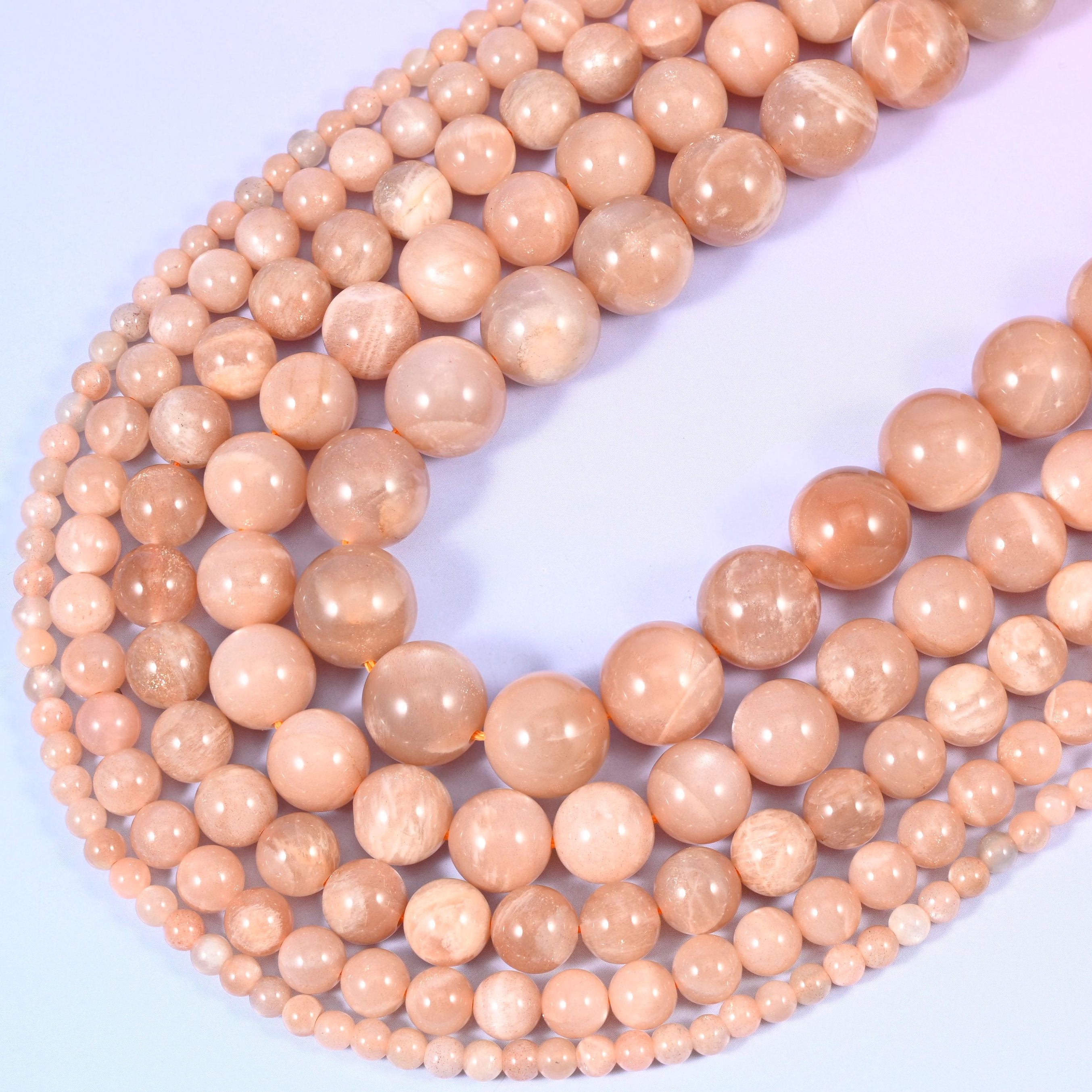 Peach Moonstone Smooth Round Beads, sold per 15.5 inch strand.