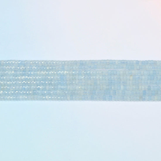 Several strands of aquamarine chalcedony faceted heishi disc beads laid in straight rows