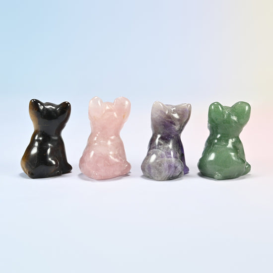 Back view of four French bulldog carvings in tiger eye, rose quartz, amethyst and green aventurine