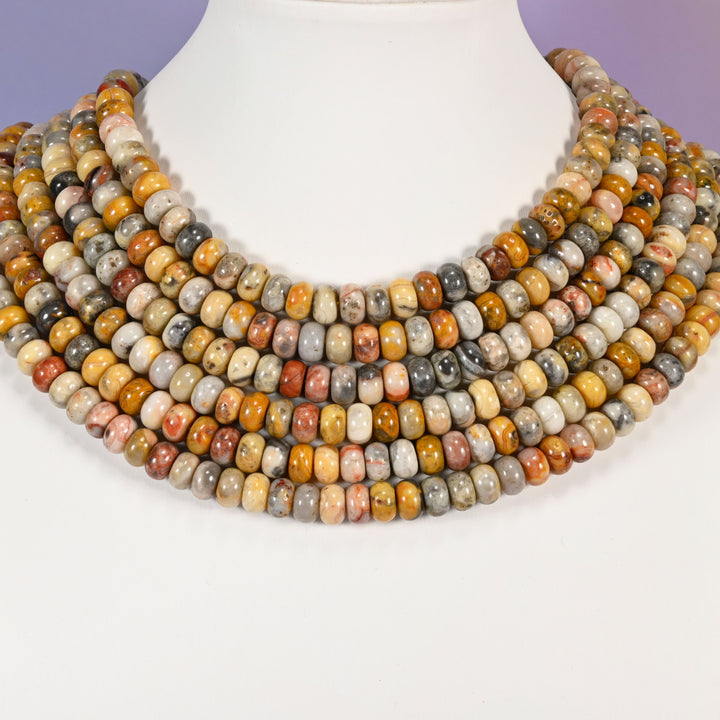 Multi-strand Crazy Agate necklace laid flat on a mannequin neck form against a lavender background.
