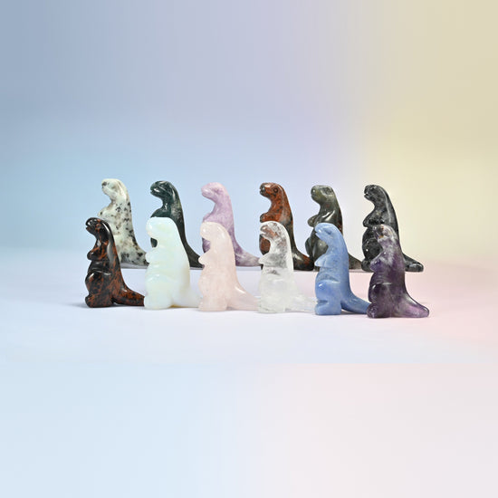 Group of 2 inch T-Rex dinosaur crystal carvings in natural kiwi jasper, Indian agate, rose quartz, golden swan, labradorite, clear quartz, blue aventurine and amethyst