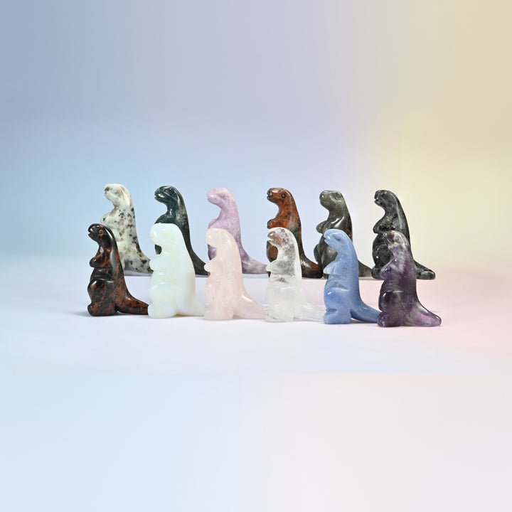 Group of 2 inch T-Rex dinosaur crystal carvings in natural kiwi jasper, Indian agate, rose quartz, golden swan, labradorite, clear quartz, blue aventurine and amethyst