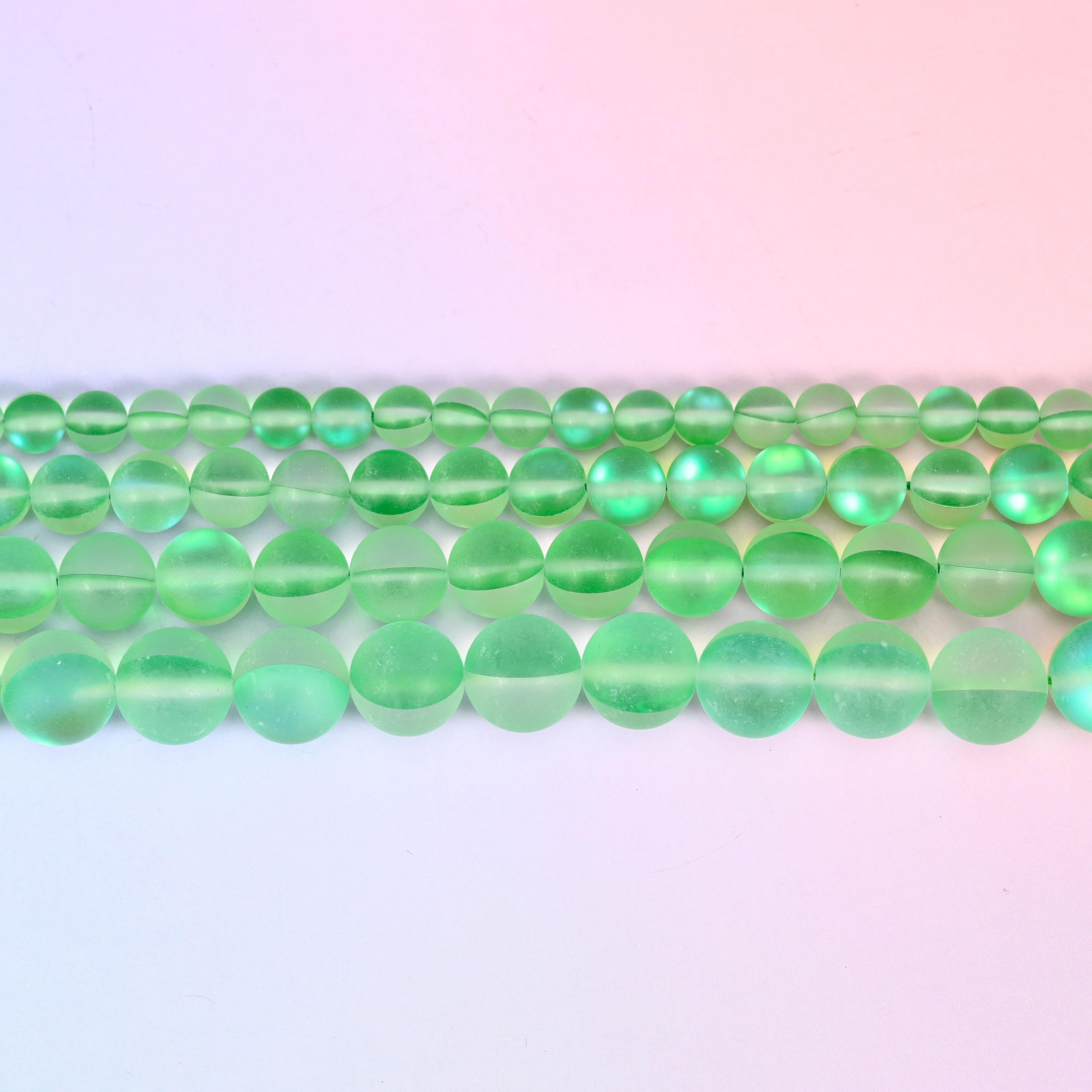 Matte glass beads in fresh apple green with a cool blue-green flash