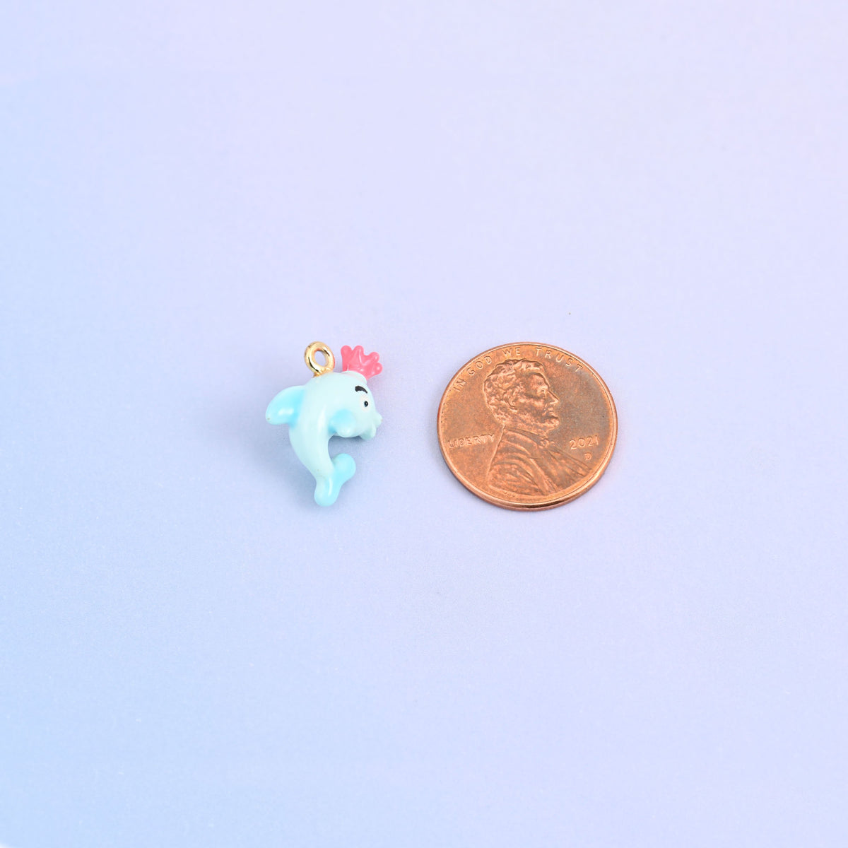 Dolphin charm with crown at actual size, 17.30 x 13.10mm across and 9mm thick.