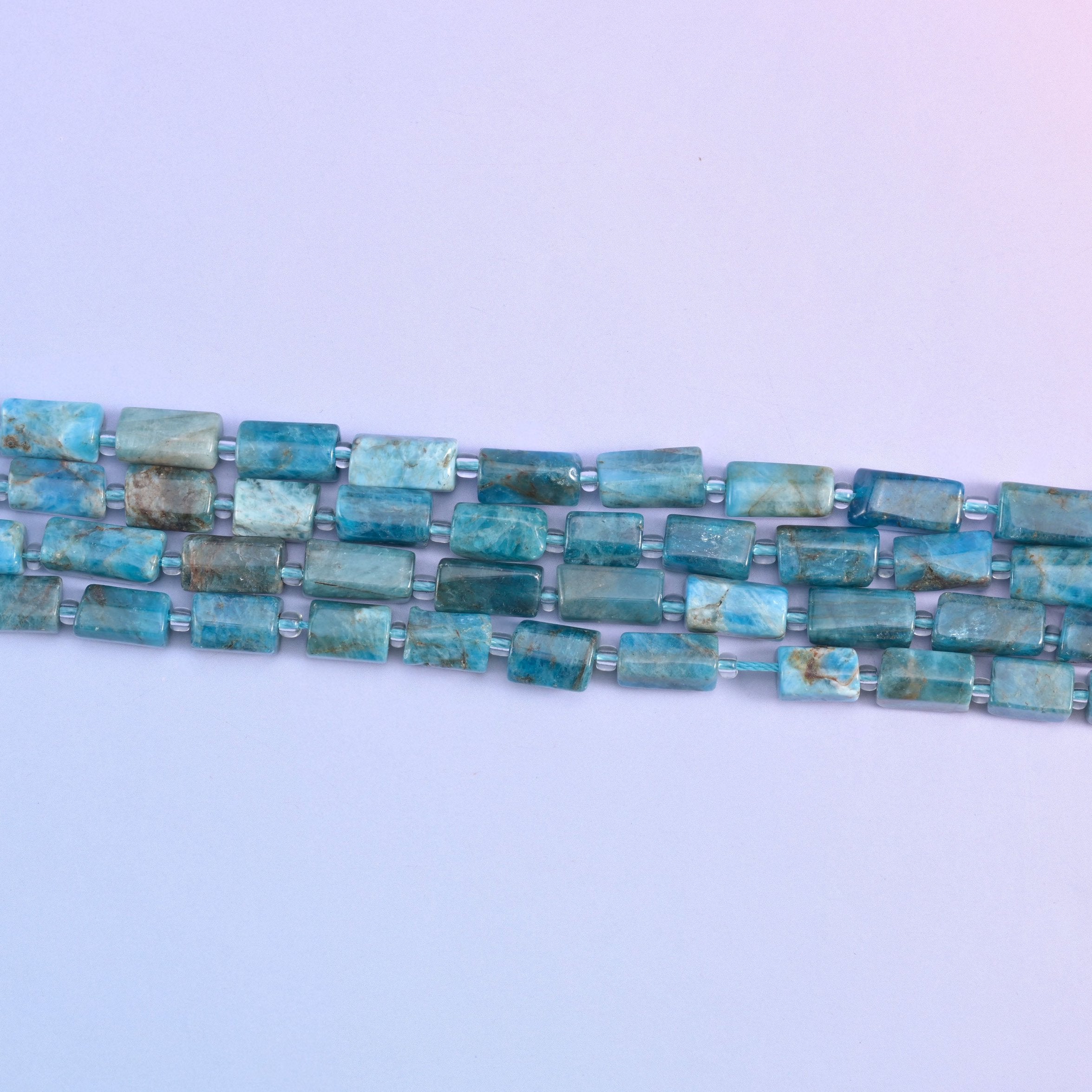 Blue apatite beads in natural color variation
