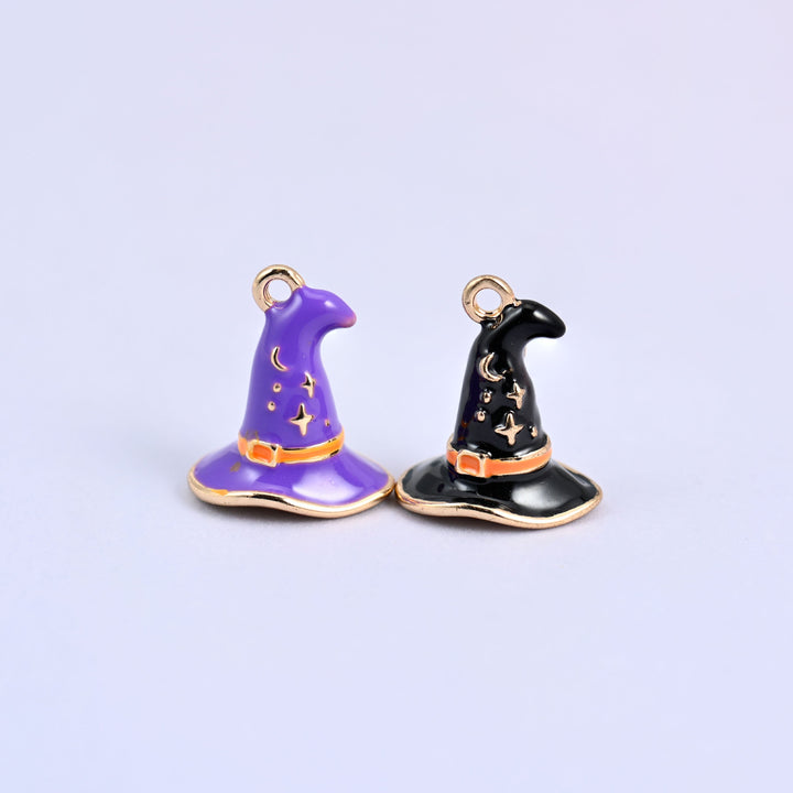 Enamel witch hat charms in purple and black side by side, each with an orange band and gold-tone stars and a crescent moon.