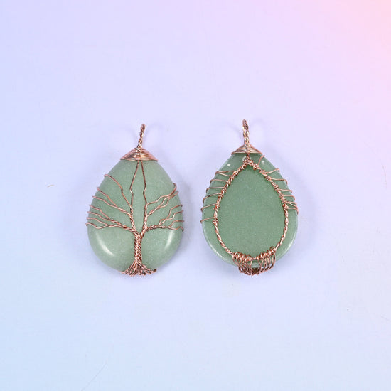 Teardrop Crystal Pendant with Copper Wired Tree in green aventurine, front and back together against a soft lilac gradient background.