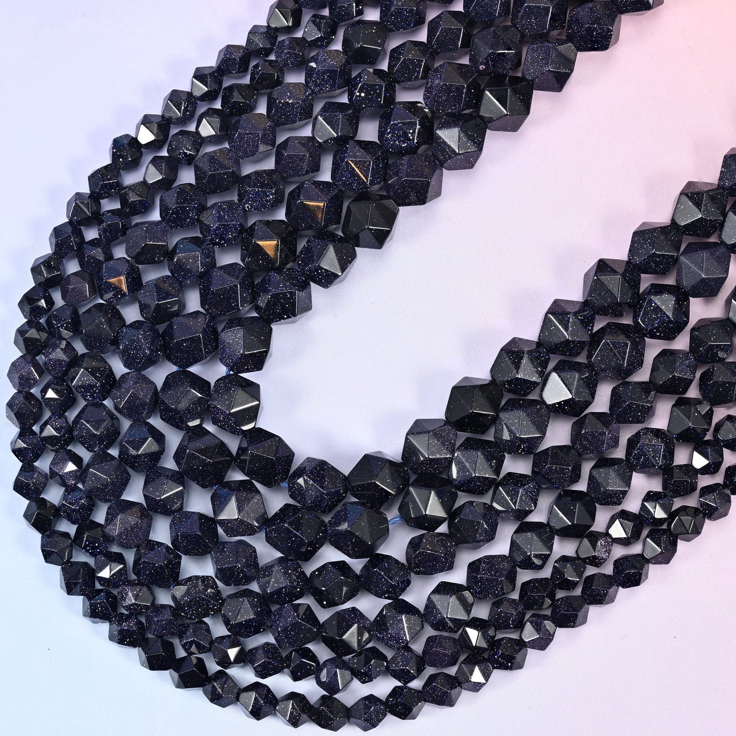 Long strands falling in a V, showing how the star facets pick out bright highlights along each edge