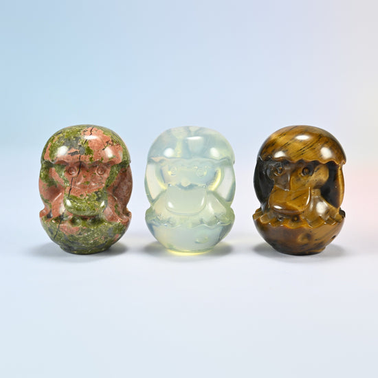 Three duck egg gemstone carvings in natural unakite, opalite (man-made glass) and natural tiger eye