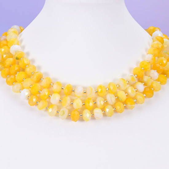 Dyed Yellow Strip Agate Faceted Rondelle Beads in warm egg-yolk gold with buttery cream and milky white banding