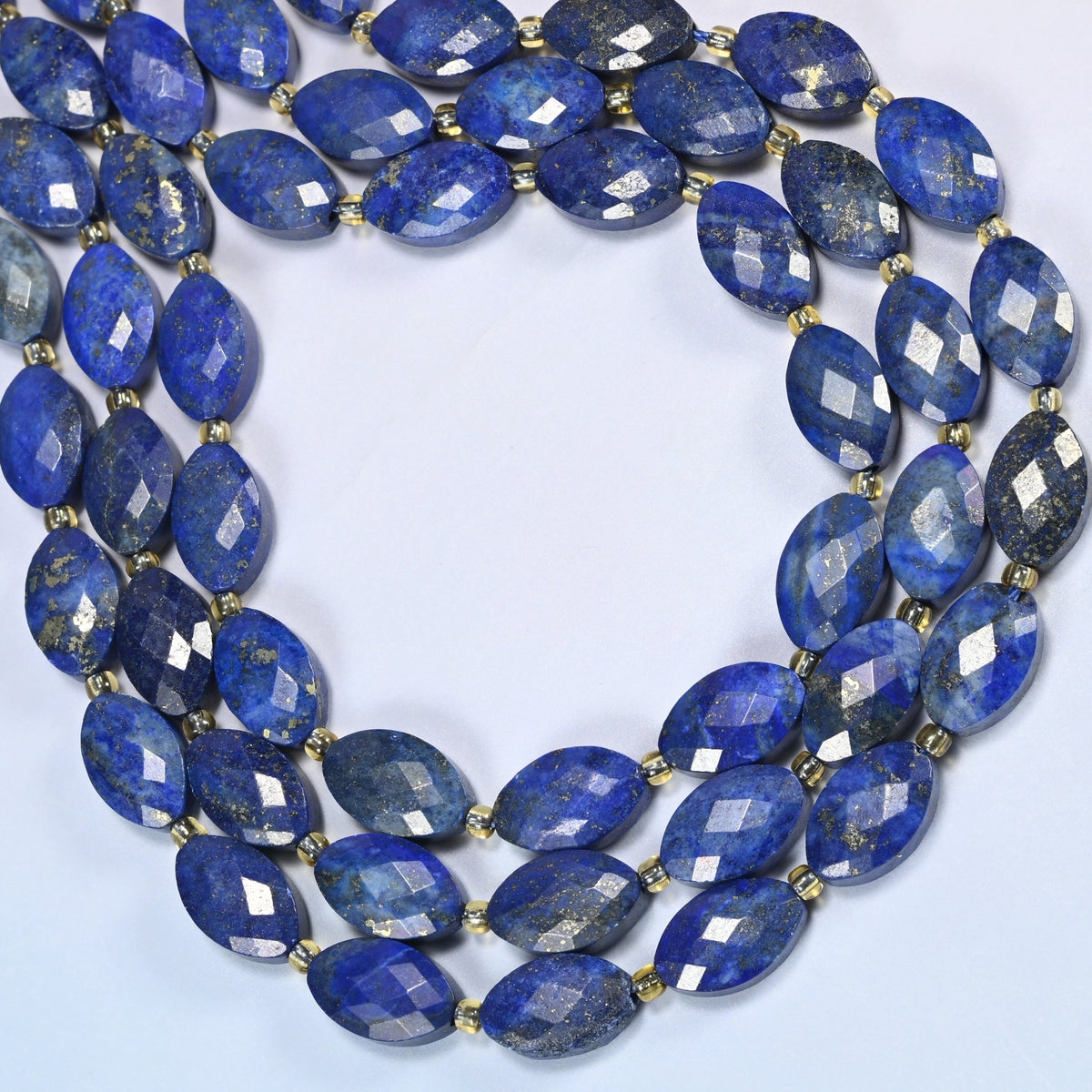 Lapis lazuli faceted flat oval beads curved into an open loop, royal blue beads with gold pyrite flecks
