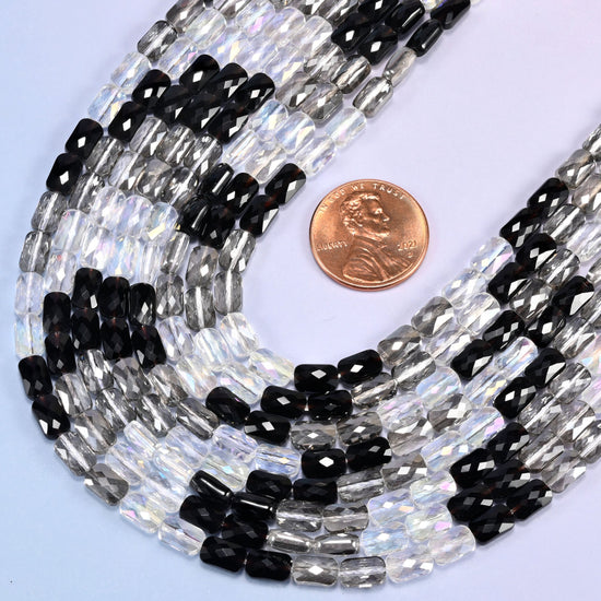 Black gray clear faceted rectangle glass beads looped with a US penny resting inside the curve.