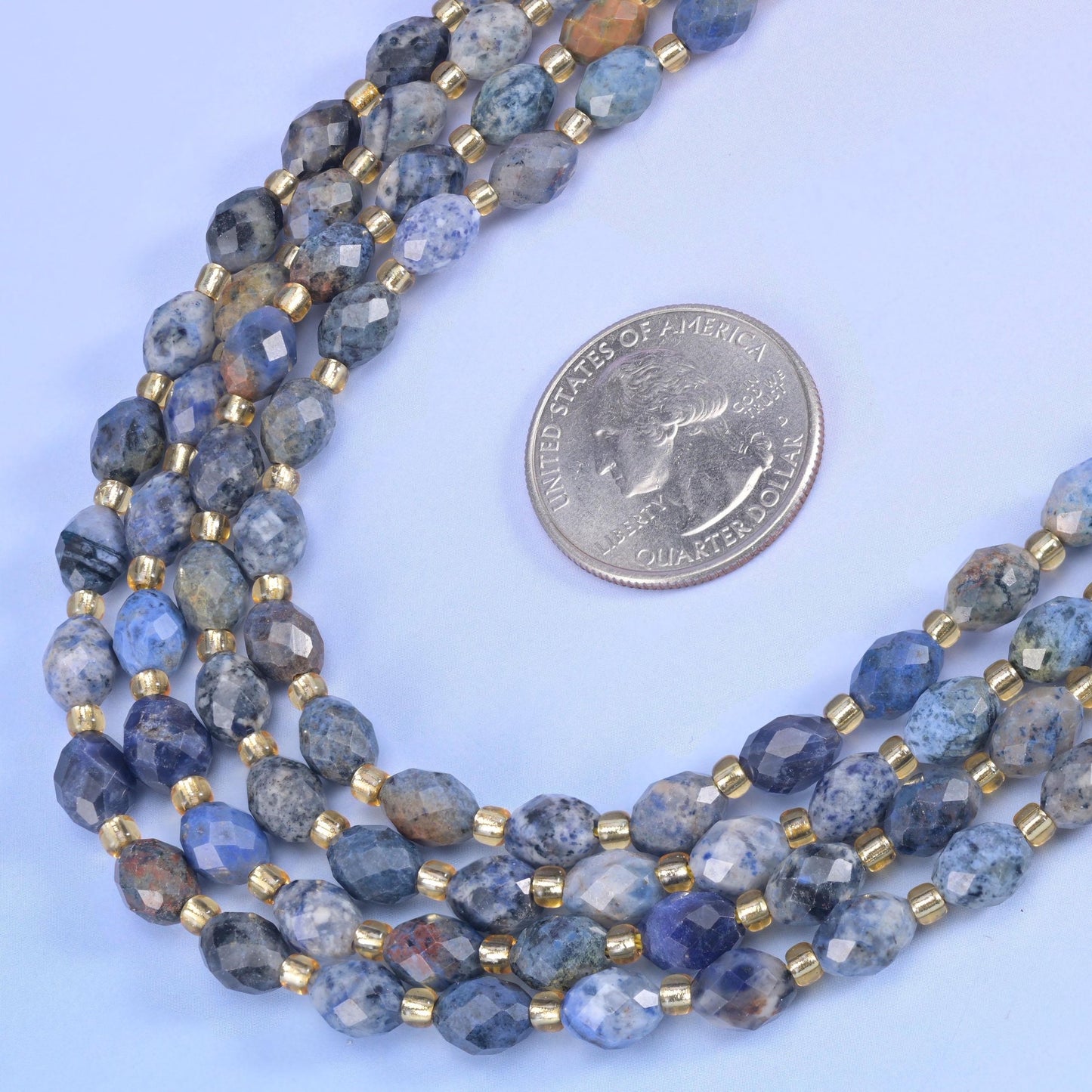Sunset Dumortierite Faceted Rice Barrel Beads in denim blue mottled with pale grey and tan