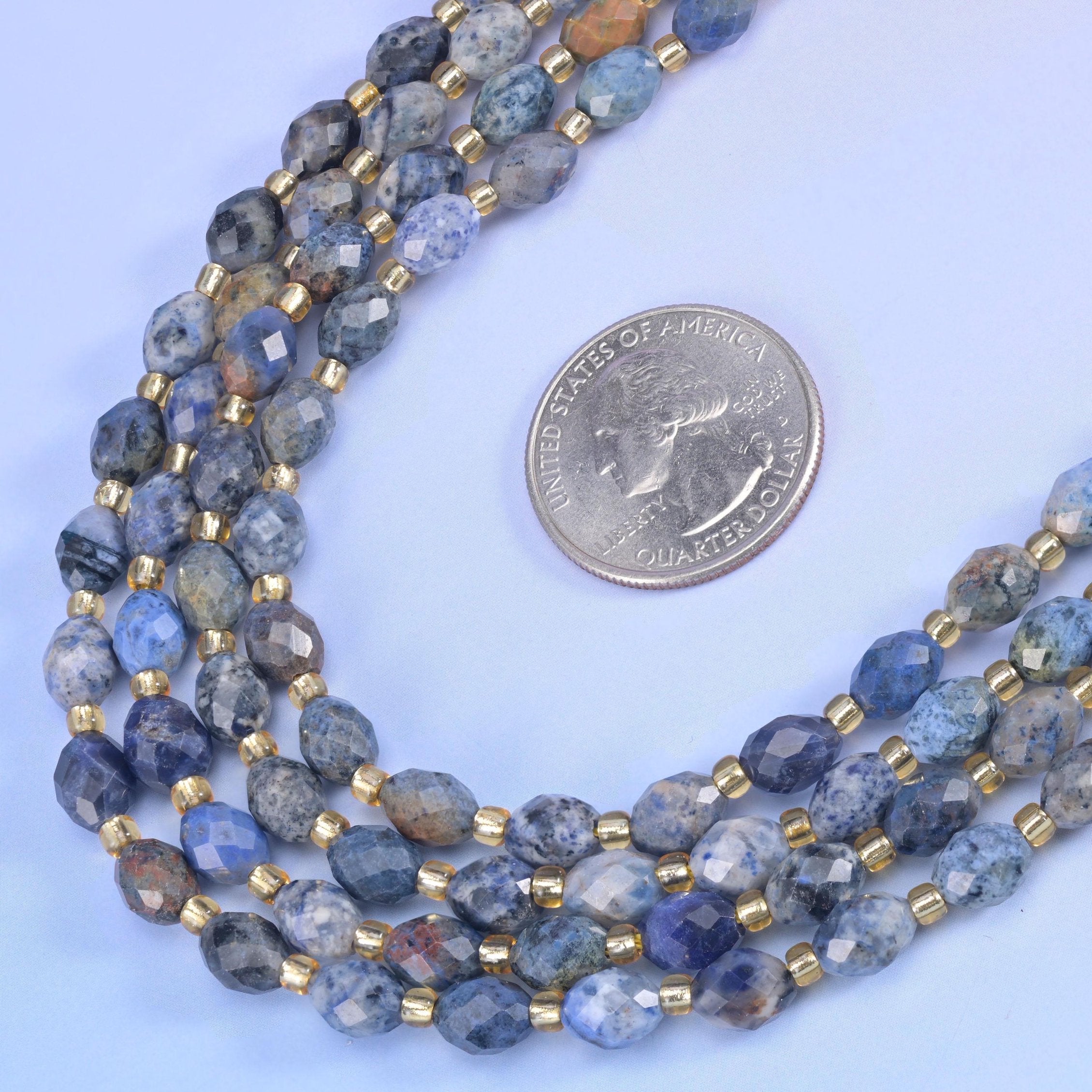 Sunset Dumortierite Faceted Rice Barrel Beads in denim blue mottled with pale grey and tan