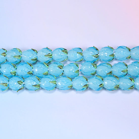 Tulip flower bud lampwork glass beads in translucent sky blue with green leaf detail