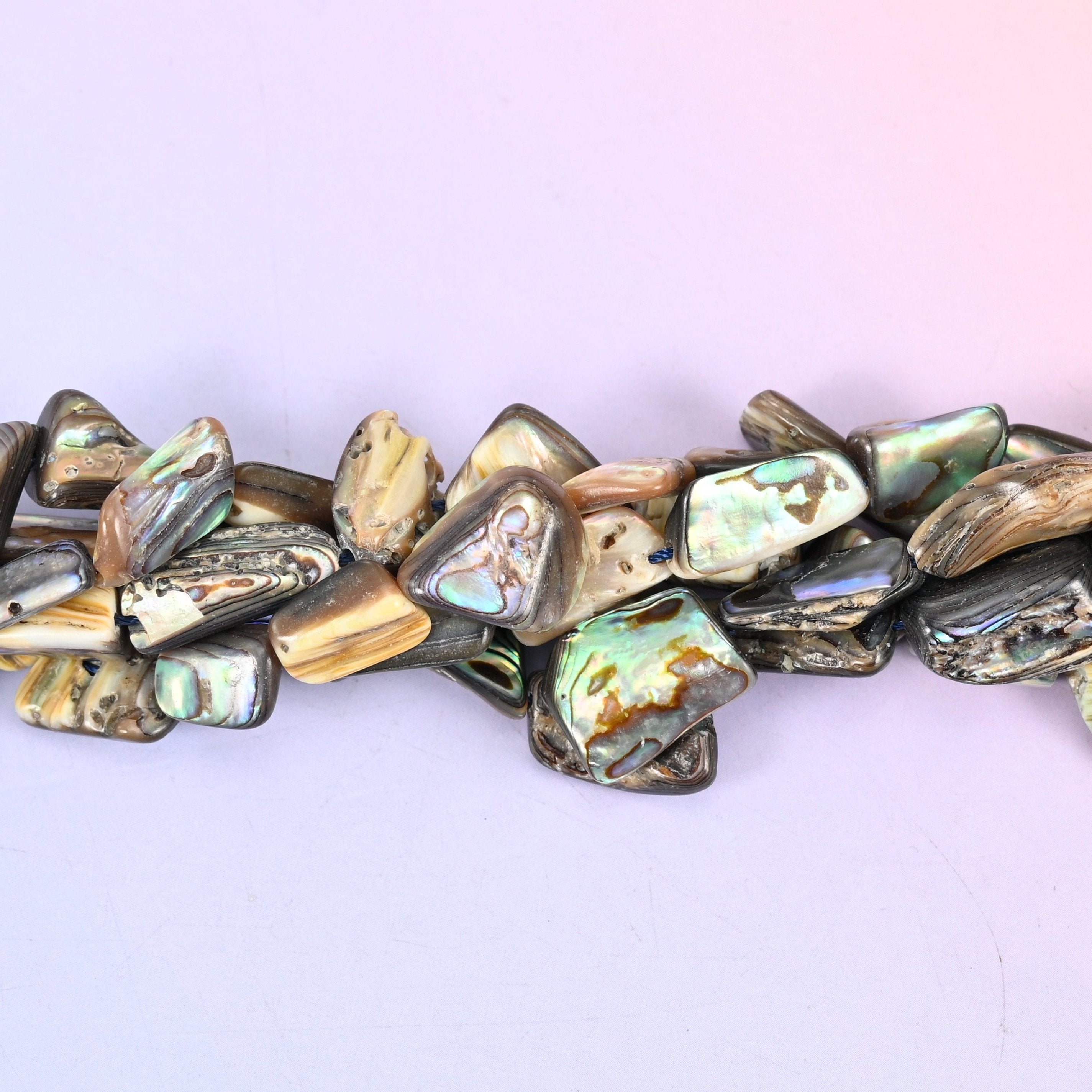 Abalone Shell Freeform Beads — irregular flat slabs cut from abalone shell, polished on one face to bring up the peacock green, blue and silver iridescence over cream and smoky grey.