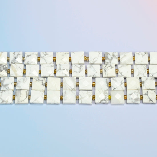 Several strands of white howlite faceted flat square beads laid in straight rows