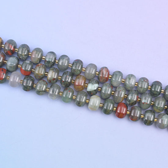 Angled run of 12x8mm pumpkin rondelles across pale lilac, gold seed beads between each stone