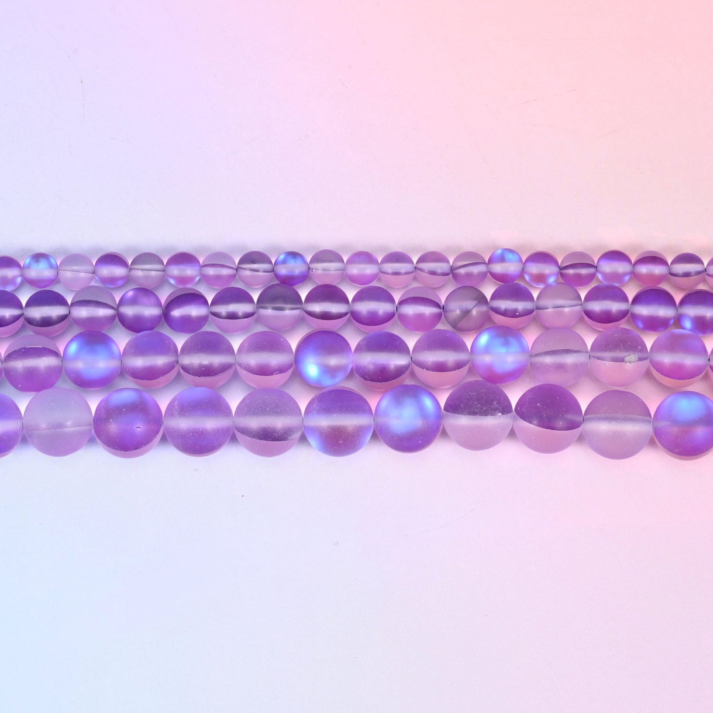 Matte glass beads in soft violet and lilac with a cool blue-lilac flash