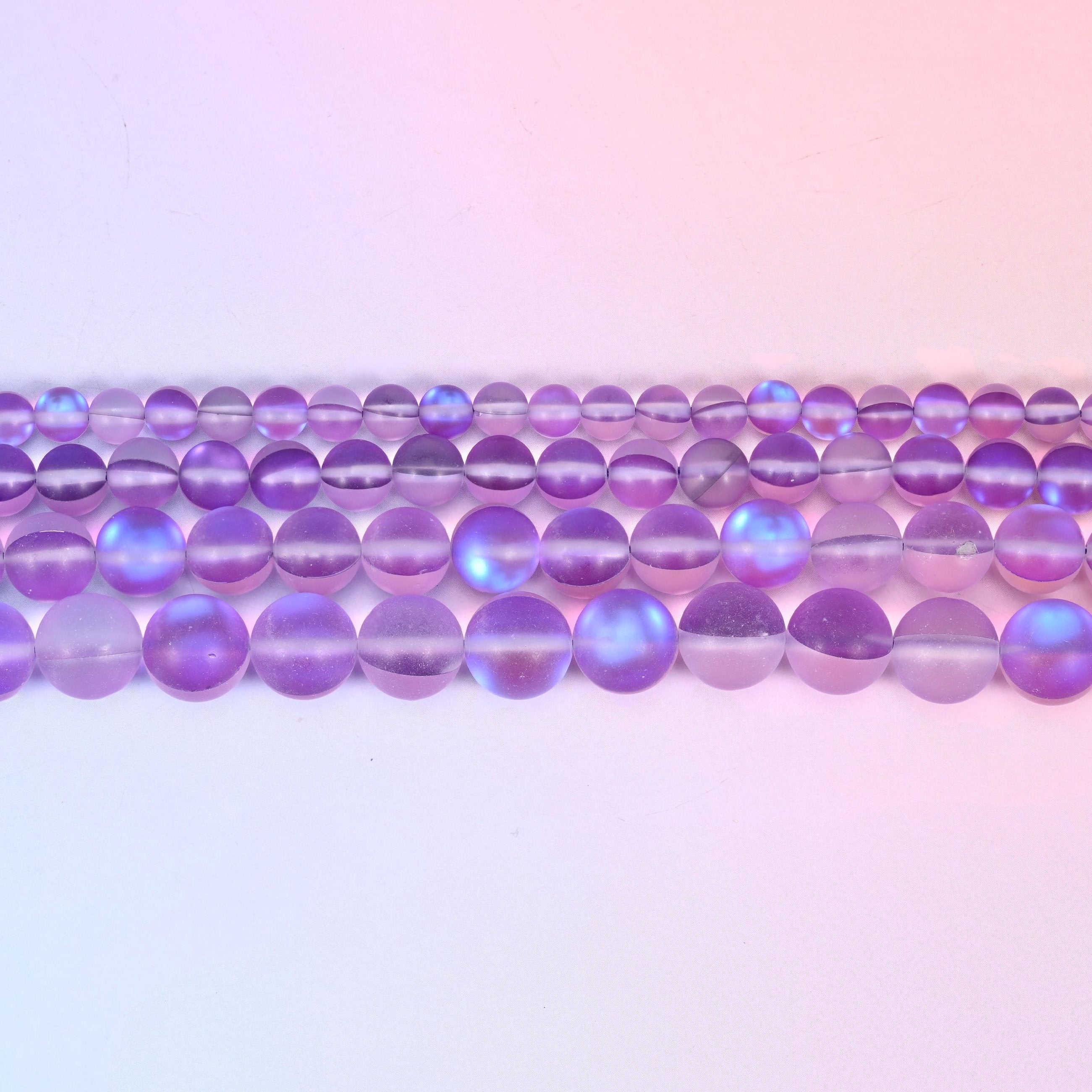 Matte glass beads in soft violet and lilac with a cool blue-lilac flash
