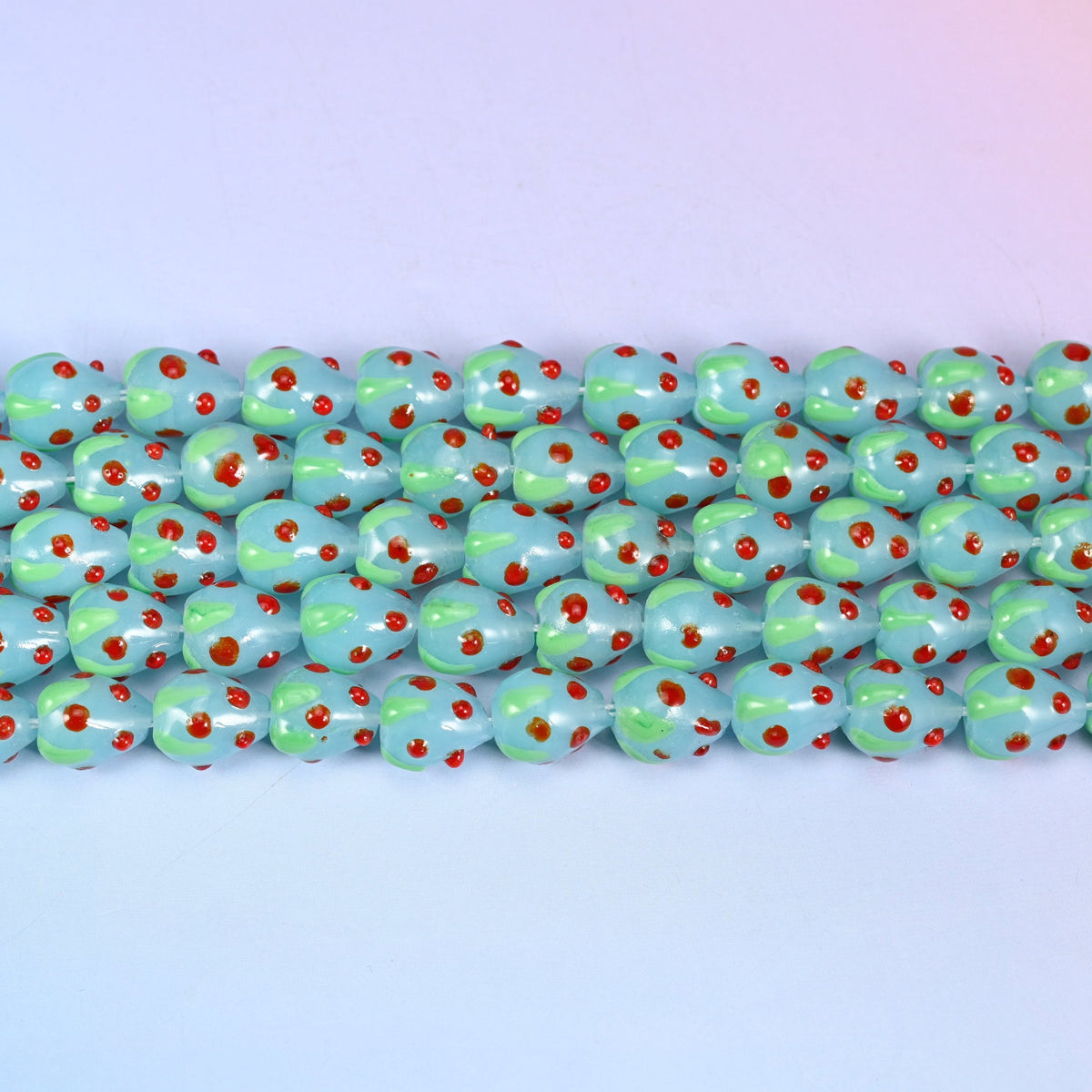 Light Blue Red Dots Strawberry Glass Beads in soft powder-blue with a pale green leaf panel