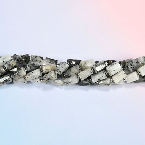 Strands of black rutilated quartz faceted tube beads twisted together in a horizontal row