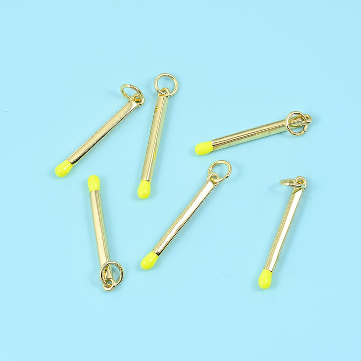 Enamel matchstick pendant in neon yellow, six gold bar charms with yellow tips and open jump rings.