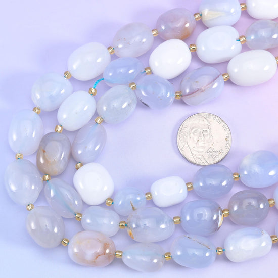 US quarter set beside coiled chalcedony nugget strands to show the range of bead sizes