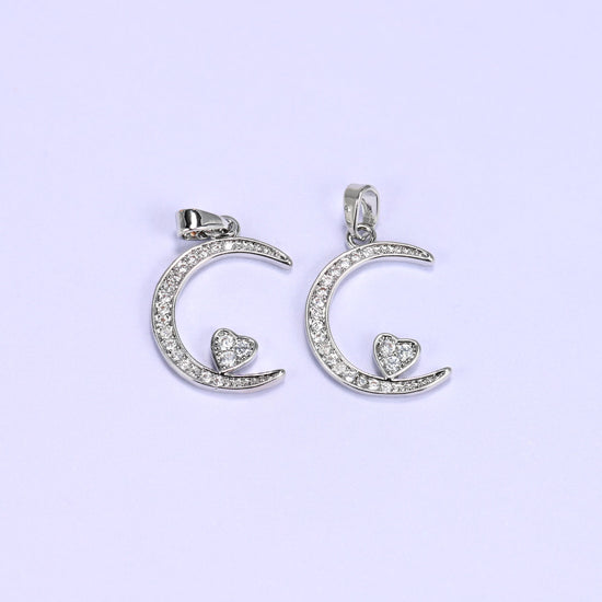 Silver moon heart zirconia charms paired side by side, both crescent pendants set with clear pave stones.