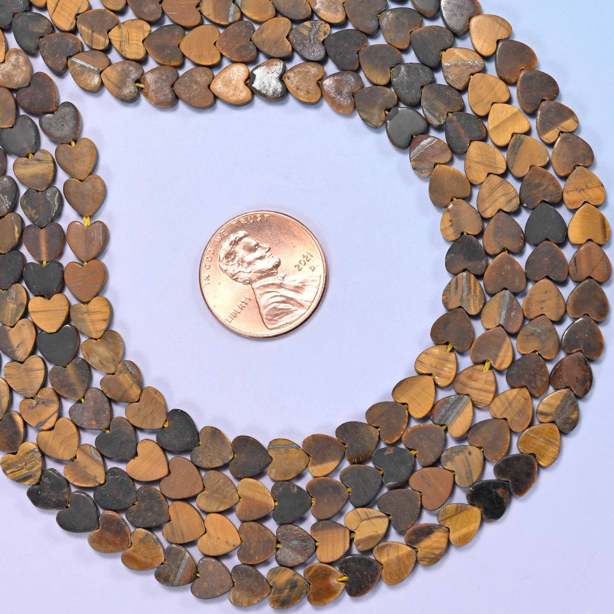 Matte Tiger Eye Flat Heart Beads, caramel, walnut and grey-brown banding under a sandblasted matte surface