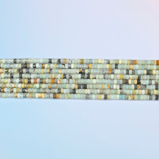 Several strands of multi-color amazonite faceted heishi disc beads laid in straight rows