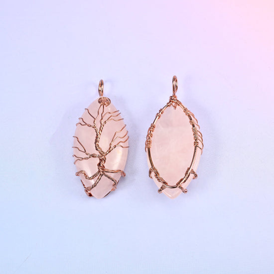 Oval Crystal Pendant with Copper Wired Tree in blush pink, front and back together against a soft lilac gradient background.