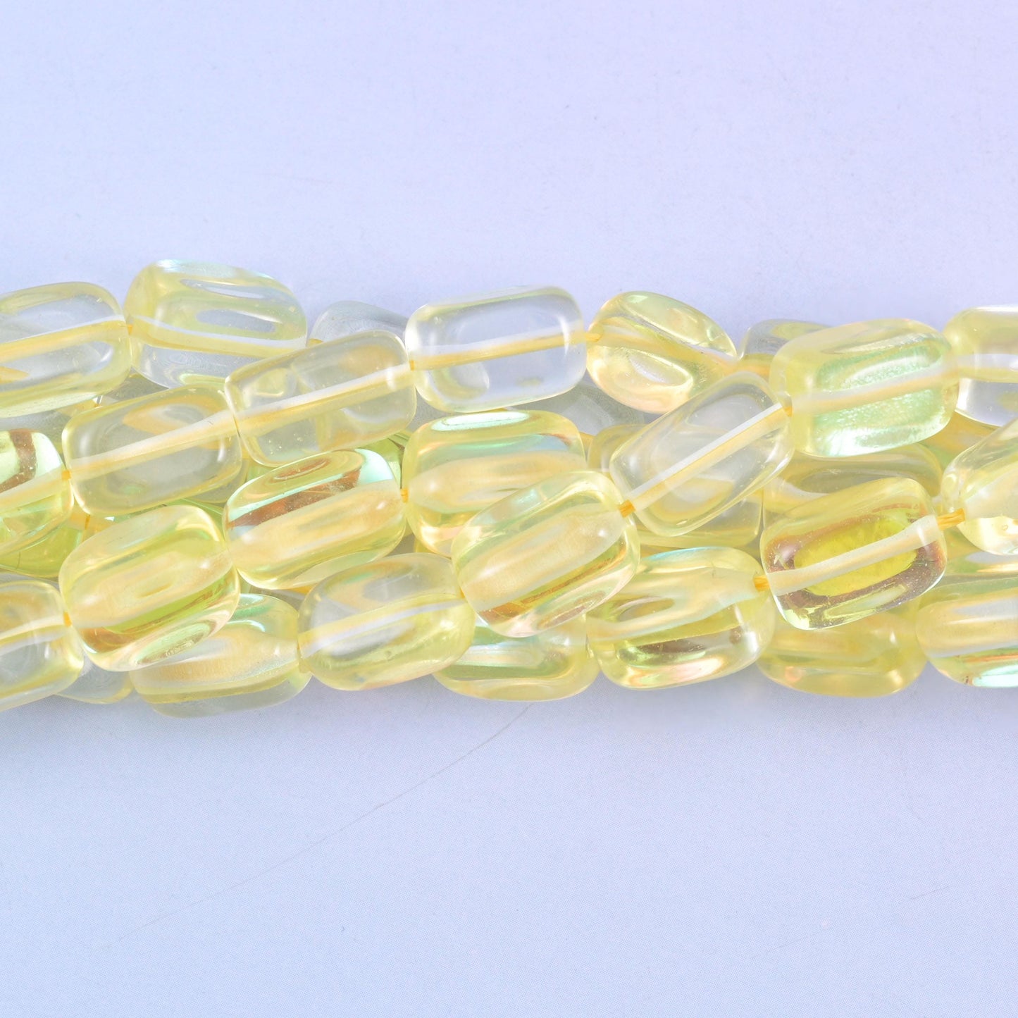 Rectangular cut glass beads with a glossy transparent finish and iridescent mystic aura coating