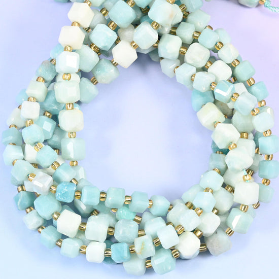 Soft sky blue amazonite clouded with cream and chalky white, cut into cubes with the corners knocked back into facets. Semi-opaque and cool toned
